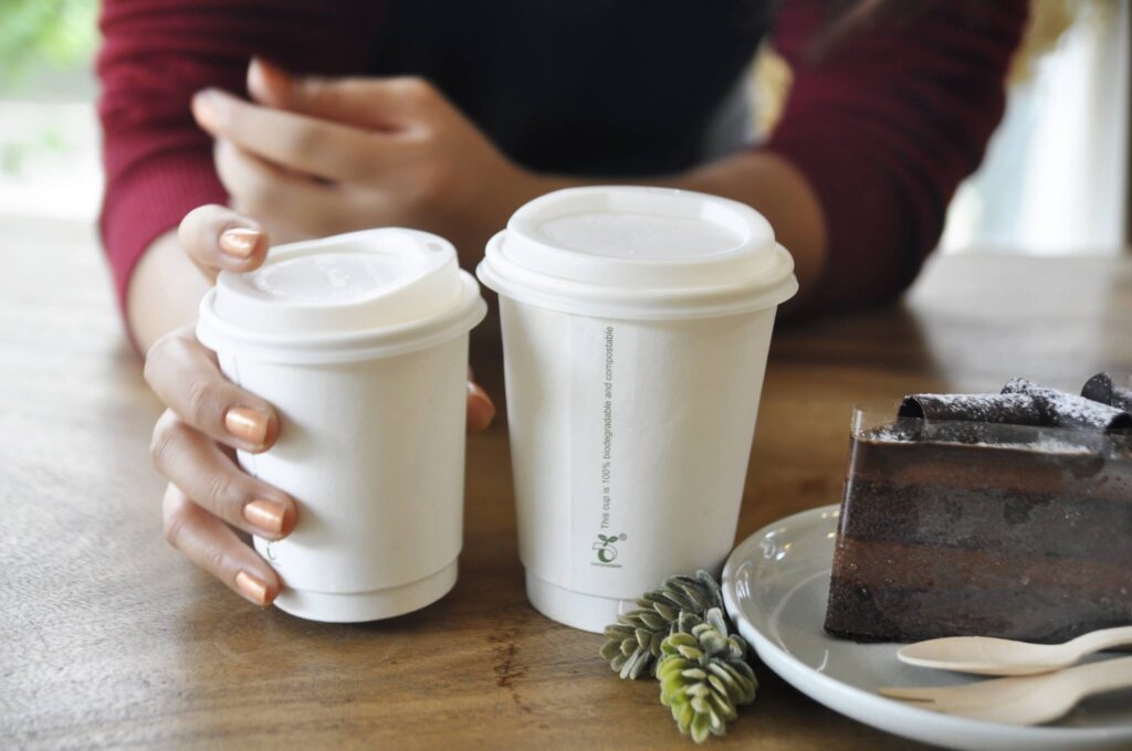 coffee paper cup man with cups in hand