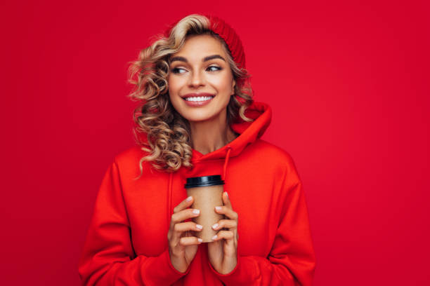 portrait of smiling girl holding disposable mug of coffee