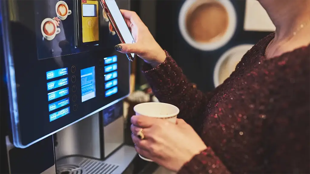 vending machine paper cups in women hand